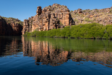 Western Australia, Kimberley Coast, Koolama Bay. Typical red rock landscape on the King George River with scenic reflections.