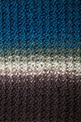 Colorful handmade winter scarf with alpacas wool macro background modern high quality prints