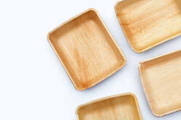 Betel palm leaf plates on white background.