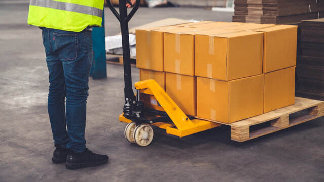 Factory workers deliver boxes package on a pushing trolley in the warehouse . Industry supply chain management concept . - Powered by Adobe