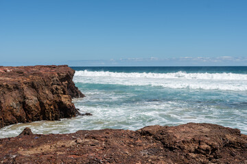 waves crashing on rocks on beach