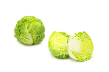 Fresh organic brussels sprouts whole and two halves isolated on white background.