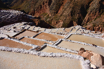 The beautiful landscapes and the stunning view of salt pans of Maras at sunset, Sacred Valley, Peru 