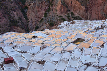 The beautiful sunset reflections on the salt pans of Maras, Sacred Valley, Peru