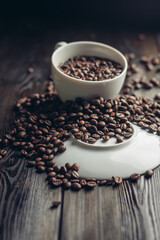 white cup and saucer coffee beans on a wooden background aroma drink