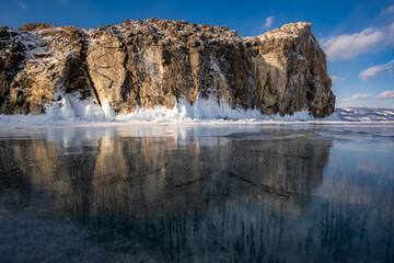 Reflection of rocks in the ice surface of Lake Baikal