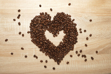 heart shaped coffee beans on wooden background