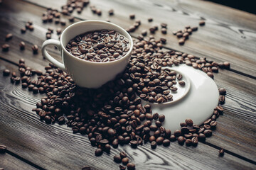 white cup and saucer coffee beans on a wooden background aroma drink