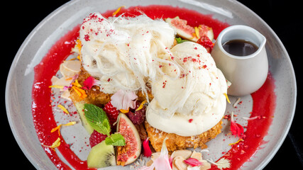 Strawberry corn flakes crusted French toasts with fresh summer fruit, coconut flakes topped with mascarpone, vanilla ice cream and silky smooth fairy floss