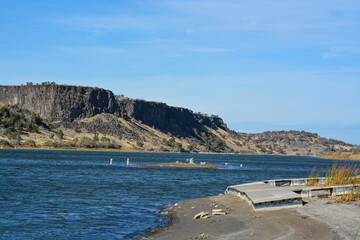 Fototapeta na wymiar Low water level exposing the rocky shore and beaching a dock on the Snake River In Northern Idaho