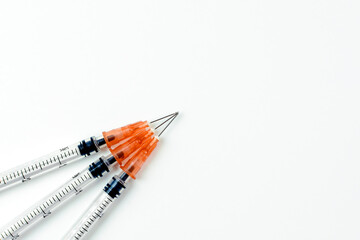 Three syringes with needles on white background. Vaccine and health concept. Coronavirus...