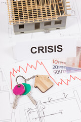 Keys, inscription crisis, euro and downward graphs representing crisis of real estate market....