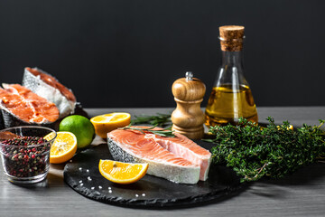 Raw salmon stesk and ingredient pepper salt dill lemon and rosemary on table. Delicious gourmet seafood dish. banner, menu recipe place for text