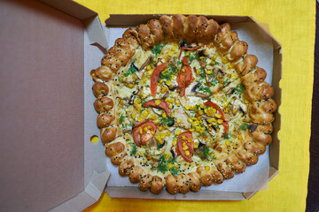 Delicious pizza on the table. Pizza with mushrooms, tomatoes, corn and sausage