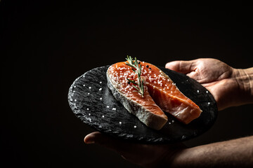 chef hands prepares fresh salmon steak fish. Marinated salmon. Salmon steak raw fish and ingredients prepared for cooking. concept for eating and healthy