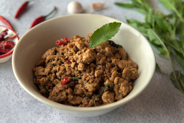 Closeup Thai food Stir fried thai basil with minced pork and bird’s eye chili in a bowl or Phat kaphrao, pad krapow, kaprao, is one of the most popular thai food.