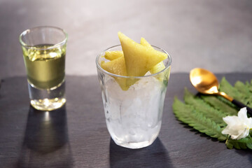 Dessert made with glutinous rice wrapped in banana leaves, triangle shape, boiled, eaten with syrup and ice. Thai Dessert; called Kao Tom Nam Woon. 