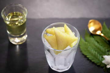 Dessert made with glutinous rice wrapped in banana leaves, triangle shape, boiled, eaten with syrup and ice. Thai Dessert; called Kao Tom Nam Woon. 