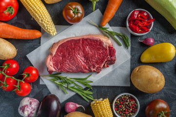 Raw beef steaks rib eye and vegetables