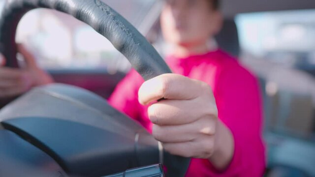 A Man Wearing A Red Shirt Is Driving A Car