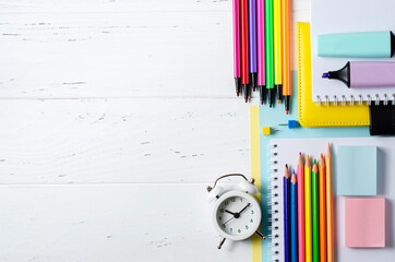 Children's accessories for study, creativity and office supplies on a white wooden background. Back to school concept. Copy space