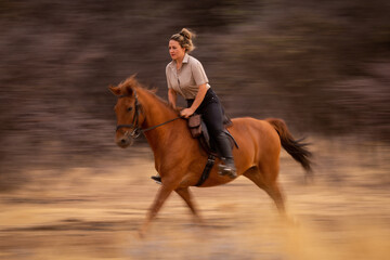 Slow pan of blonde trotting past trees