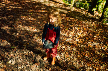 Preschooler with charcoal in the woods on an autumn day