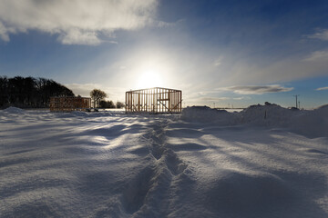 Fototapeta na wymiar New residential construction of wooden frame house cold winter weather