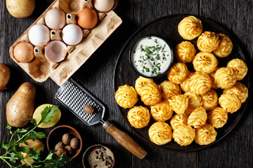 Duchess potatoes served on a black plate