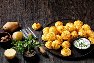 Duchess potatoes served on a black plate