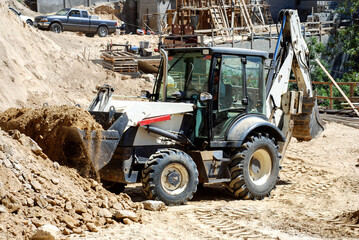 Moving soil with a backhoe
