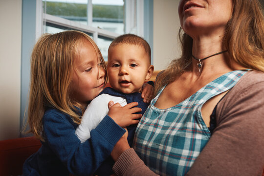 Mother at home with baby and preschooler