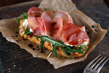 Bruschetta with parma on a wooden board for serving