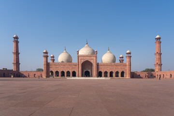 Front view of beautiful ancient Badshahi mosque with courtyard built by mughal emperor Aurangzeb a landmark of Lahore, Punjab, Pakistan