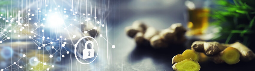 Ginger root whole and sliced. Ginger tea with lemon on the dark background. Fresh ginger root on stone background. Vitamins. Free space for your text.