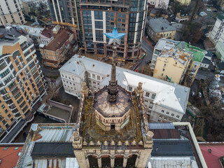 House with a five-pointed star on a spire in the center of Kiev. Aerial drone view. Winter cloudy morning.