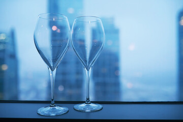 Cocktail glasses on the windowsill by the glass