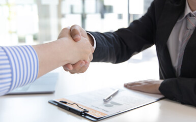 Close-up hand to hand, Congratulations on joining the new employee, Welcome with a handshake, Express their joy in being able to qualify for a new employee's job in the company, Good deal.