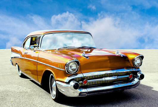 Fototapeta Yellow American vintage car from the fifties with round headlights