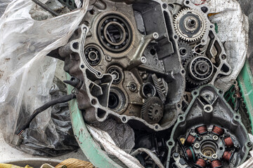 Disassembled motorcycle engine. Motorcycle powertrain parts under repair.