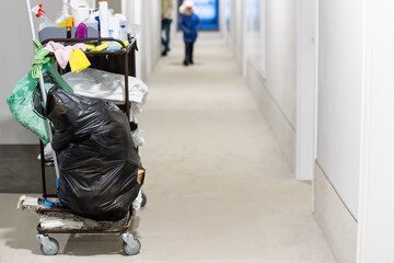 Cleaning utility janitorial cart in hotel corridor
