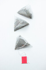 Pyramid tea bags on a white background. Blank label for an inscription or logo. Instant tea