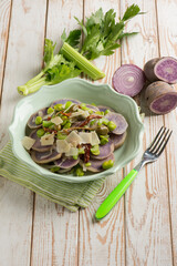vegetables salad with purple potatoes broad beans sliced parmesan cheese