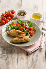 rolled sword fish with capers arugula and tomatoes salad