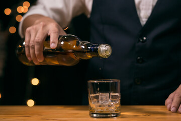 Barman pouring whiskey whiskey glass beautiful night
