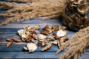 White dry mushrooms on wooden background