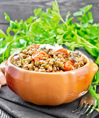 Lentils with eggplant and tomatoes in bowl on towel