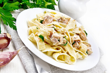 Pasta with salmon and cream on light board