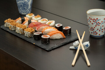 Japanese sushi food. Maki ands rolls with tuna, salmon, shrimp, crab and avocado. Close up and top view of assorted sushi. 