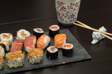Japanese sushi food. Maki ands rolls with tuna, salmon, shrimp, crab and avocado. Close up and top view of assorted sushi. 